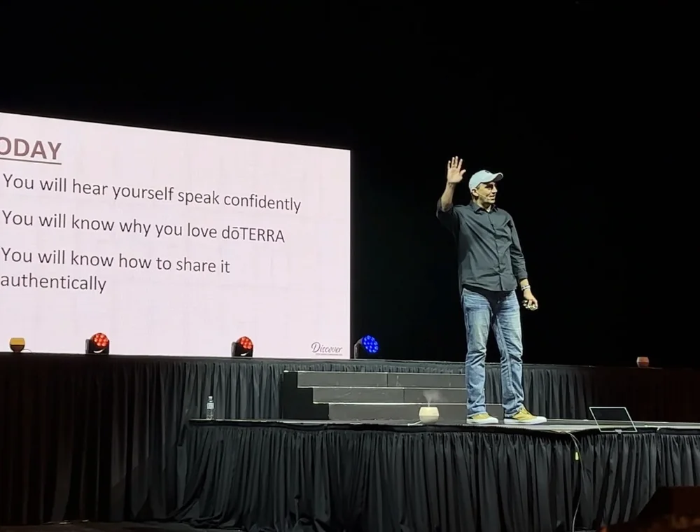 Eddie Villa teaching from a large conference stage