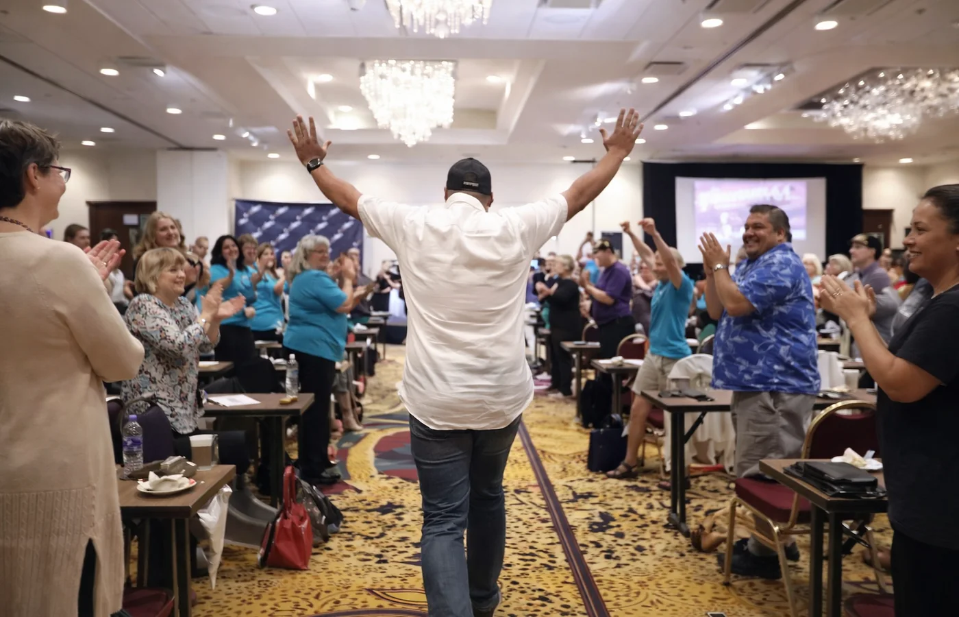 Eddie Villa standing in front of and engaging a live audience