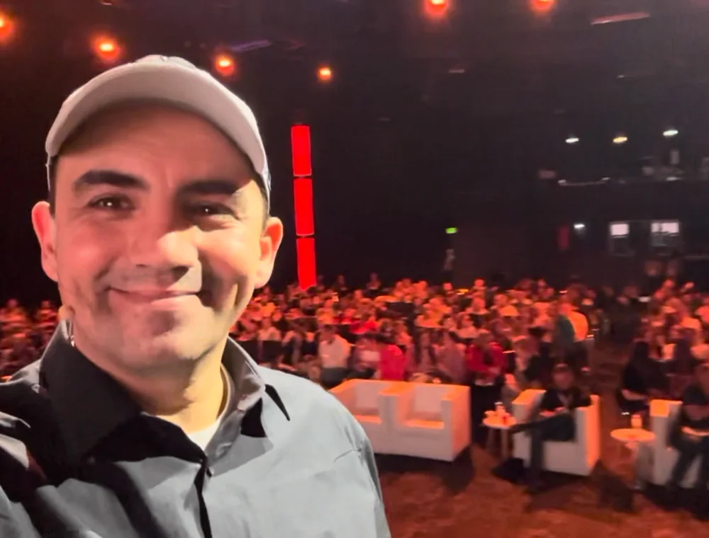 Eddie Villa in front of a large seated audience